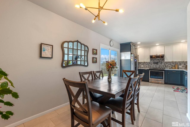 dining room with light tile patterned floors, baseboards, and an inviting chandelier