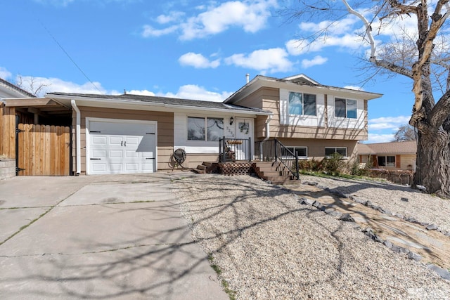 tri-level home featuring an attached garage and driveway