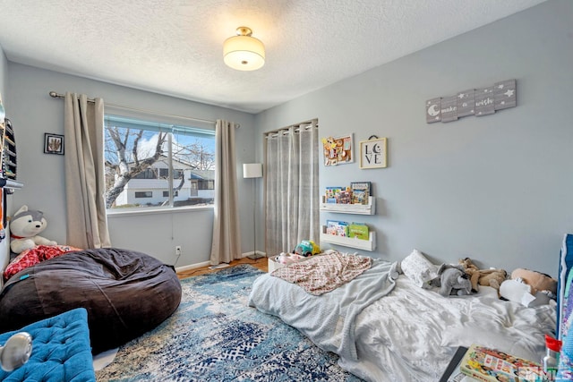 bedroom featuring baseboards and a textured ceiling