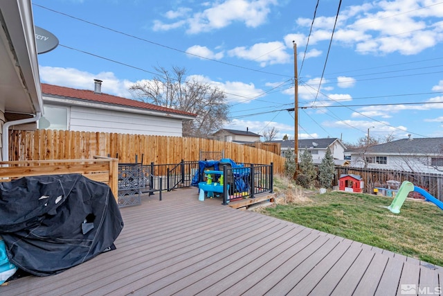 wooden deck featuring a yard and a fenced backyard