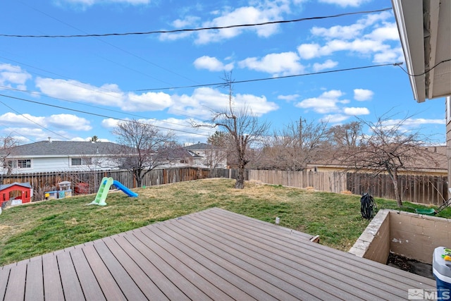 deck with a yard and a fenced backyard