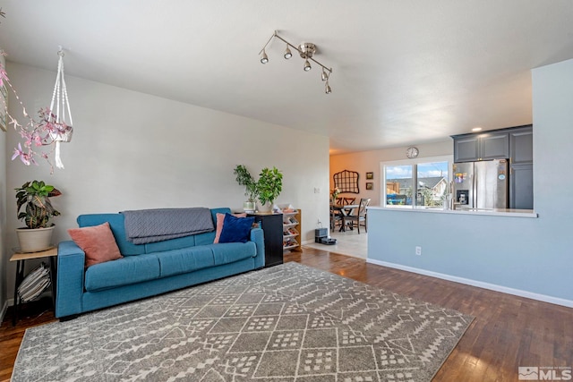 living room featuring wood finished floors and baseboards