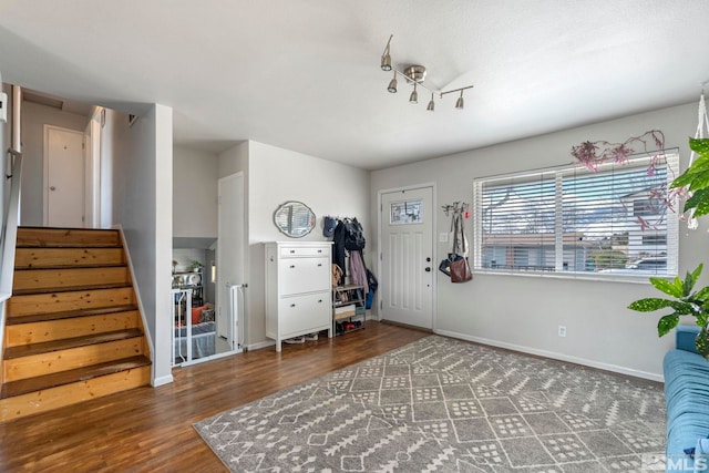 interior space featuring stairway, baseboards, and wood finished floors