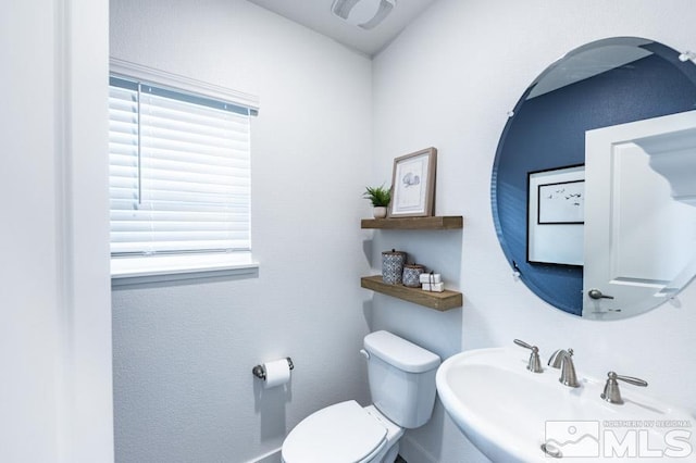 bathroom with toilet and a sink