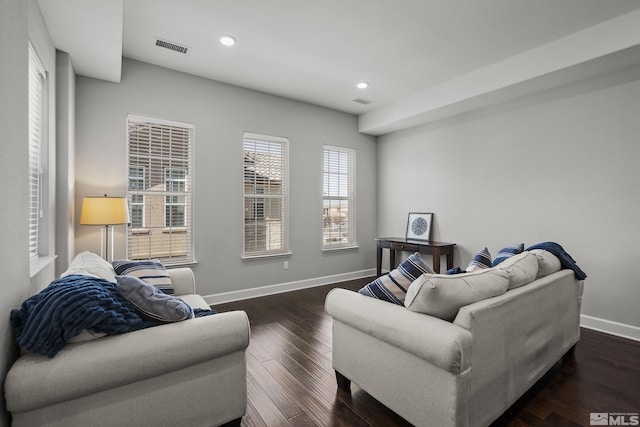 living area featuring recessed lighting, visible vents, baseboards, and dark wood-style flooring