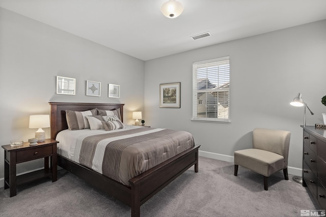 carpeted bedroom with visible vents and baseboards