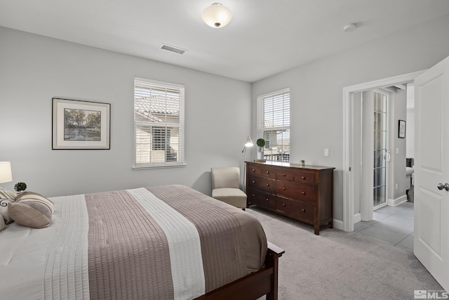 bedroom featuring visible vents and light carpet