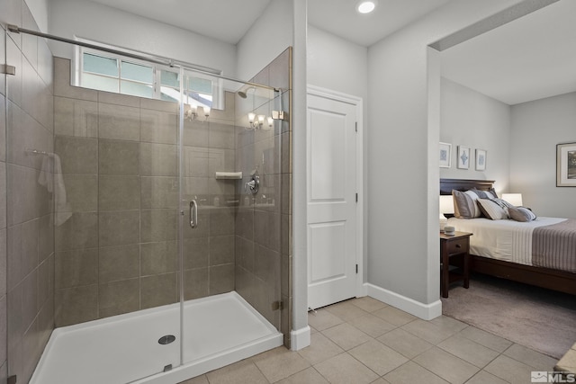 bathroom featuring connected bathroom, baseboards, a shower stall, and tile patterned flooring