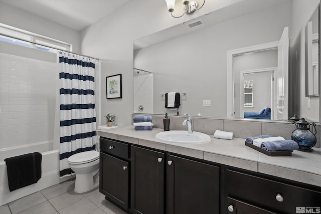 full bathroom with vanity, visible vents, shower / bath combo with shower curtain, tile patterned floors, and toilet