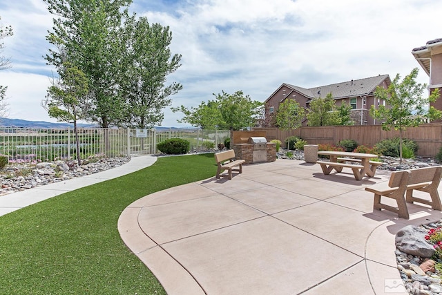 view of patio featuring area for grilling and fence