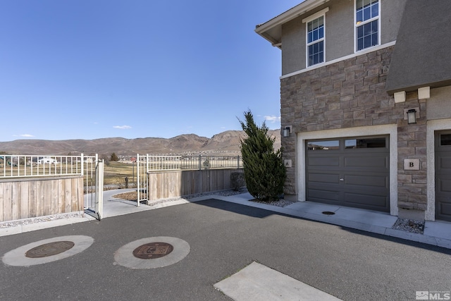 exterior space with a gate, a mountain view, and fence