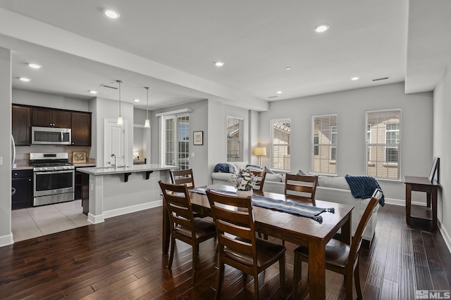 dining area featuring recessed lighting, baseboards, and light wood-style floors