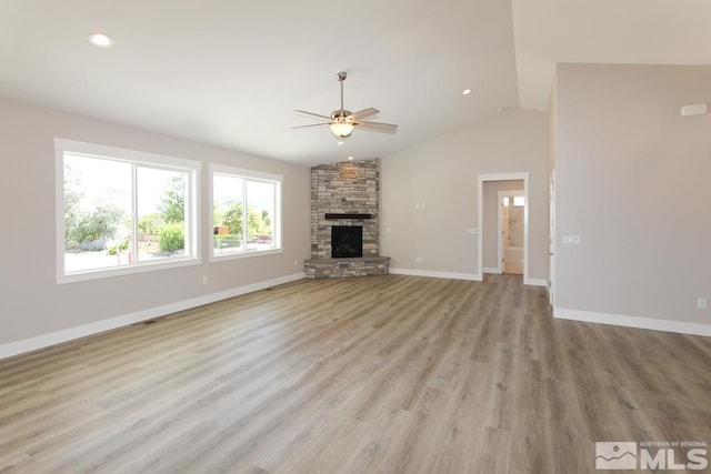 unfurnished living room featuring light wood-style flooring, a ceiling fan, recessed lighting, a fireplace, and baseboards