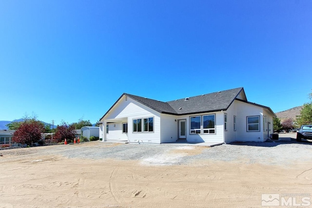 rear view of property featuring central AC