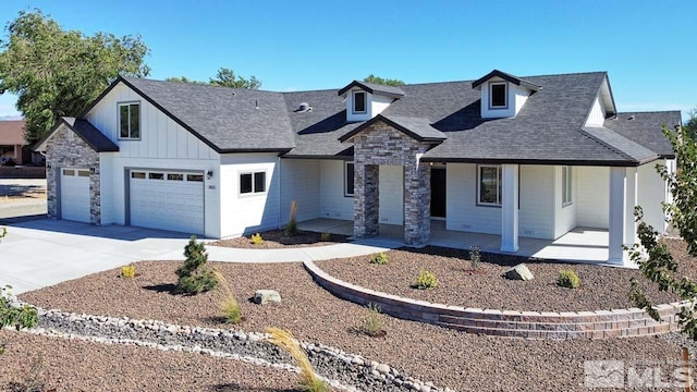 view of front of home with driveway, stone siding, a porch, board and batten siding, and a garage