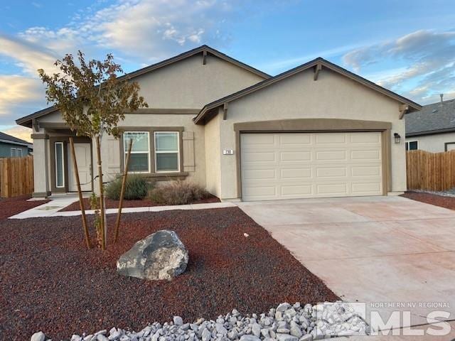 ranch-style house featuring stucco siding, concrete driveway, an attached garage, and fence