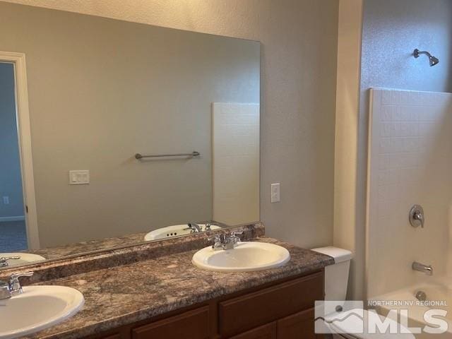 bathroom featuring a sink, washtub / shower combination, and double vanity