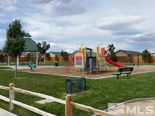 communal playground with a lawn and fence