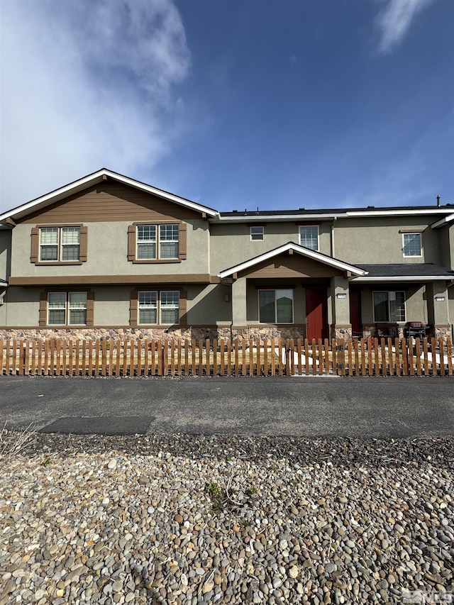 view of front of property with a fenced front yard and stucco siding