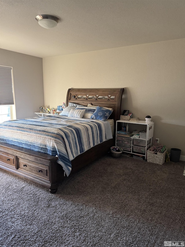 bedroom with carpet floors and a textured ceiling