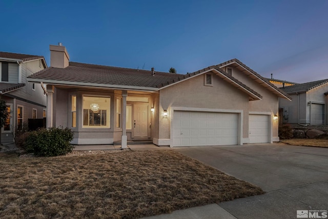 ranch-style home featuring a chimney, stucco siding, concrete driveway, a garage, and a tile roof