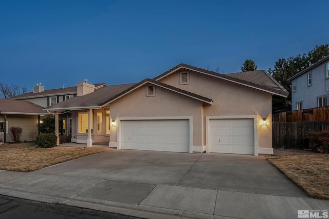 ranch-style home featuring fence, driveway, an attached garage, stucco siding, and a tiled roof