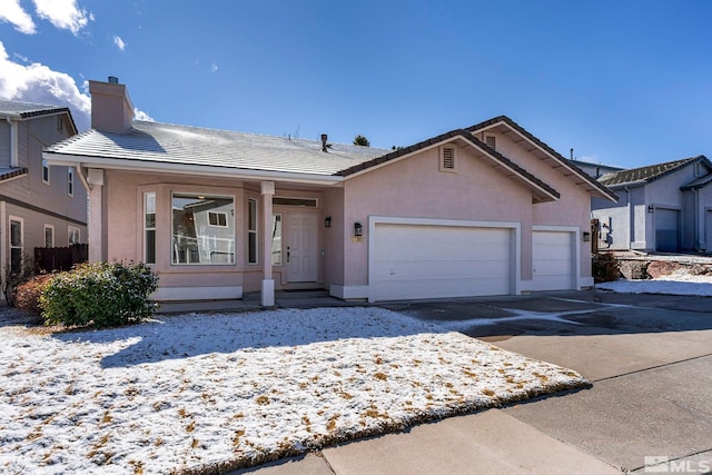 ranch-style home with a tile roof, stucco siding, a chimney, driveway, and an attached garage