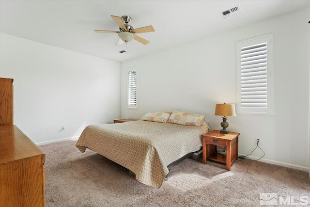 bedroom featuring carpet flooring, baseboards, visible vents, and ceiling fan