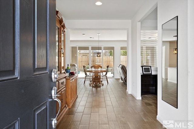 entrance foyer featuring dark wood finished floors, a notable chandelier, recessed lighting, and baseboards