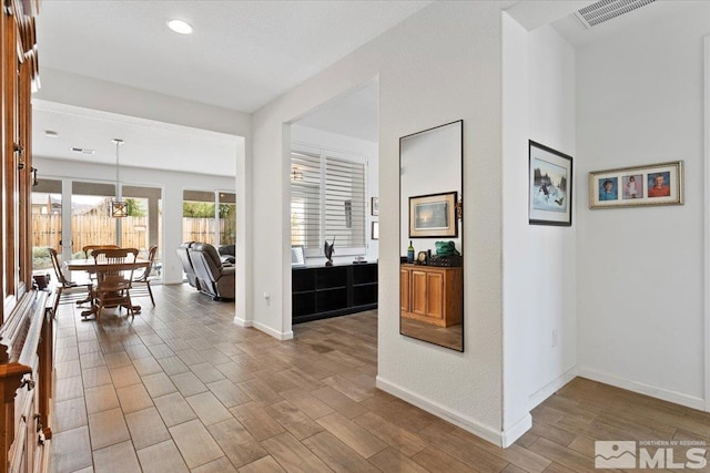 interior space featuring visible vents, recessed lighting, baseboards, and wood finished floors