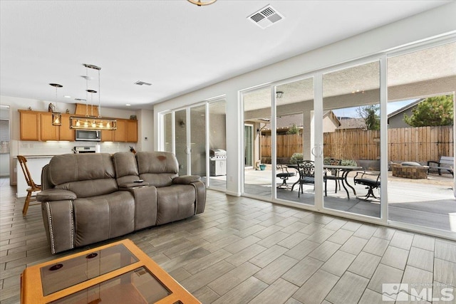 living room featuring light wood-style floors and visible vents