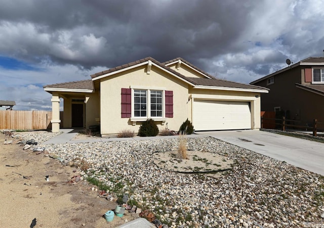 ranch-style home with fence, driveway, an attached garage, stucco siding, and a tiled roof