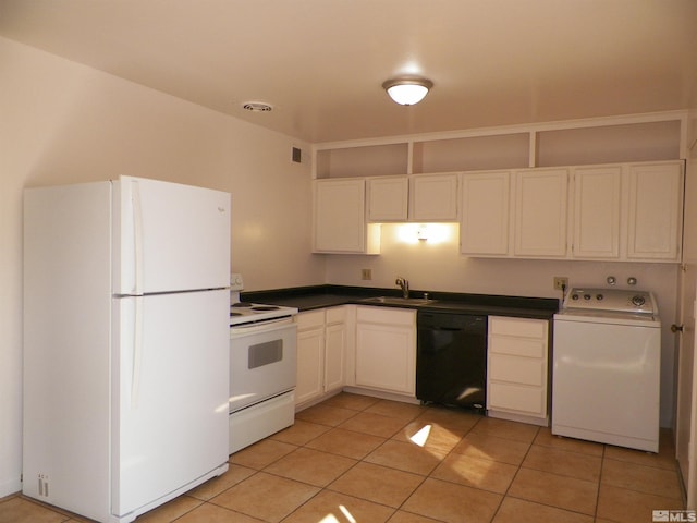 kitchen with a sink, dark countertops, white cabinetry, white appliances, and washer / dryer