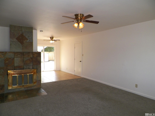 unfurnished living room with tile patterned floors, carpet flooring, baseboards, and a ceiling fan