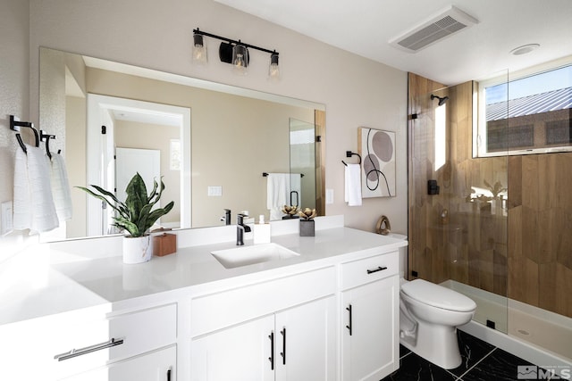 bathroom featuring visible vents, toilet, marble finish floor, tiled shower, and vanity