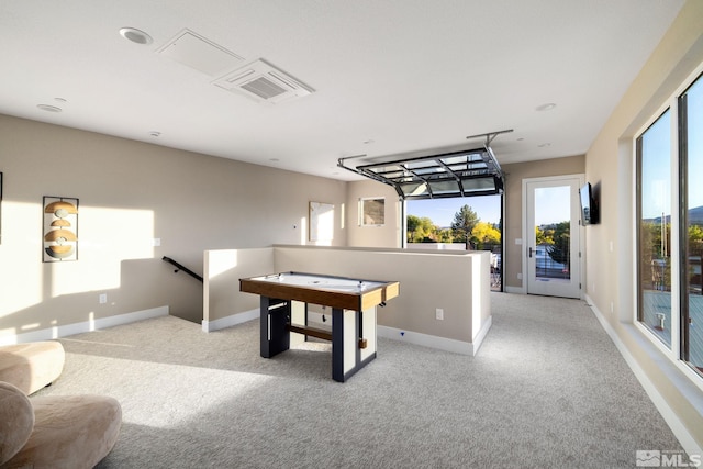 playroom with baseboards, light carpet, and a healthy amount of sunlight