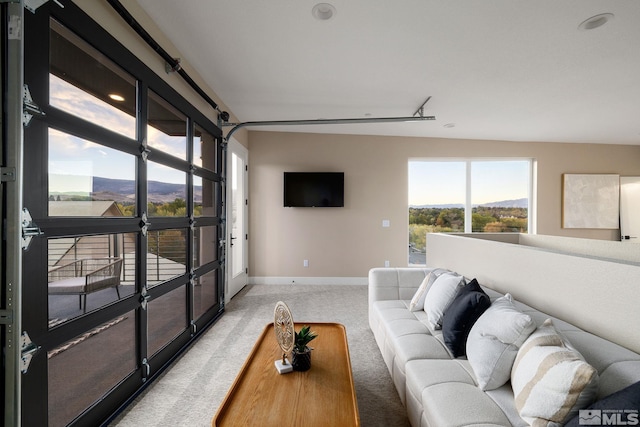 living room featuring baseboards and light carpet