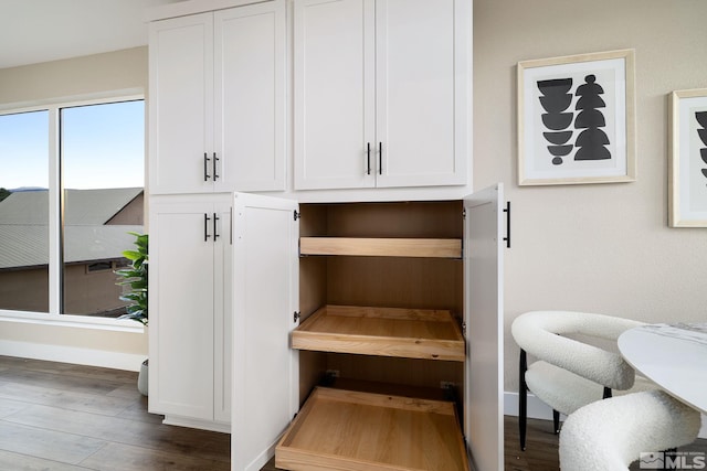 interior space featuring baseboards and wood finished floors