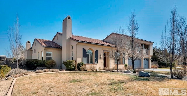 view of front of home with a front yard, an attached garage, stucco siding, concrete driveway, and a tile roof