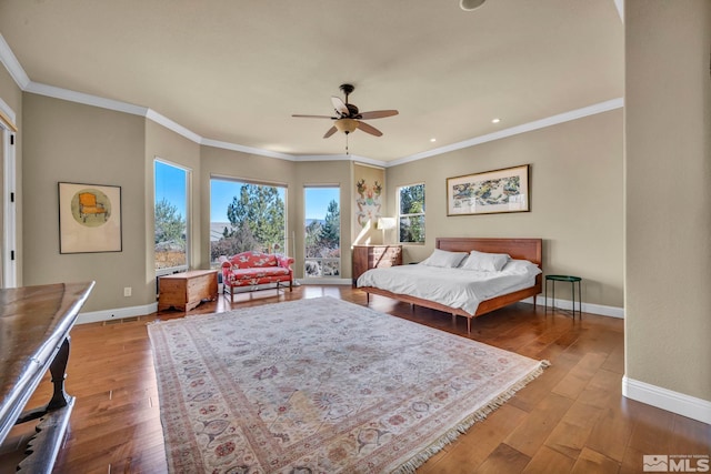 bedroom featuring visible vents, crown molding, baseboards, and hardwood / wood-style floors