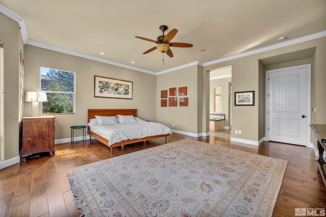 bedroom with crown molding, baseboards, and hardwood / wood-style flooring