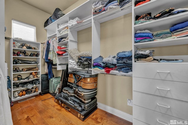 walk in closet featuring wood finished floors