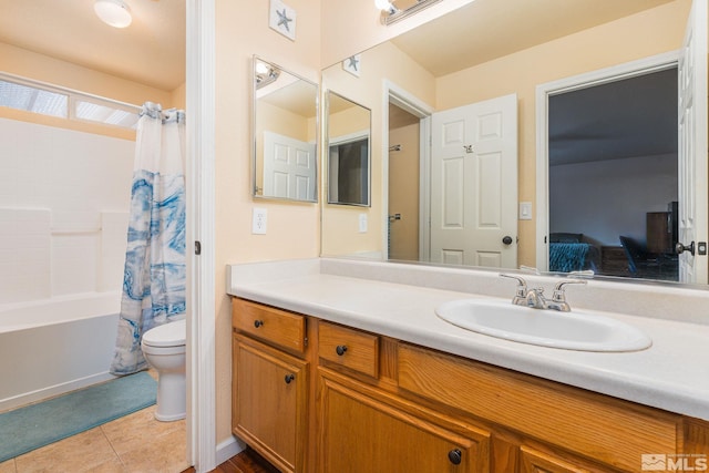 ensuite bathroom with toilet, shower / bath combo, ensuite bathroom, tile patterned floors, and vanity