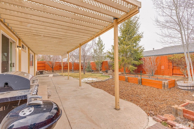 view of patio featuring a fenced backyard, a pergola, and a vegetable garden