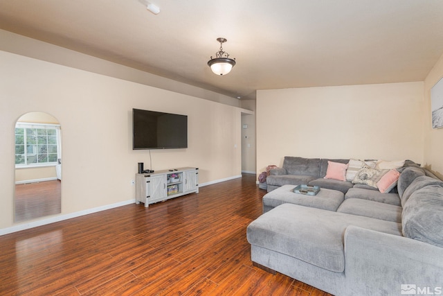 living room featuring baseboards and wood finished floors