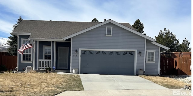 view of front of house featuring concrete driveway, an attached garage, and fence