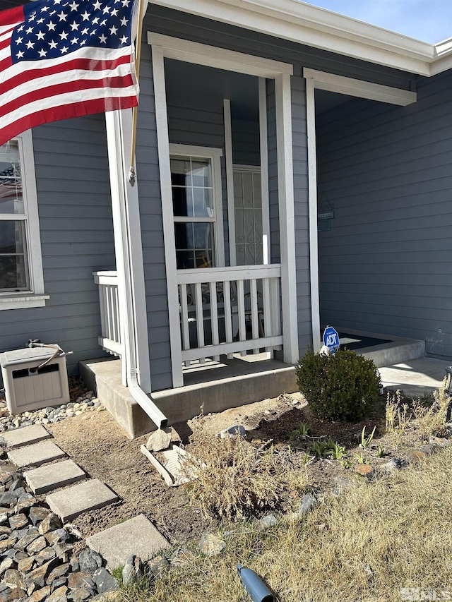 view of exterior entry with covered porch