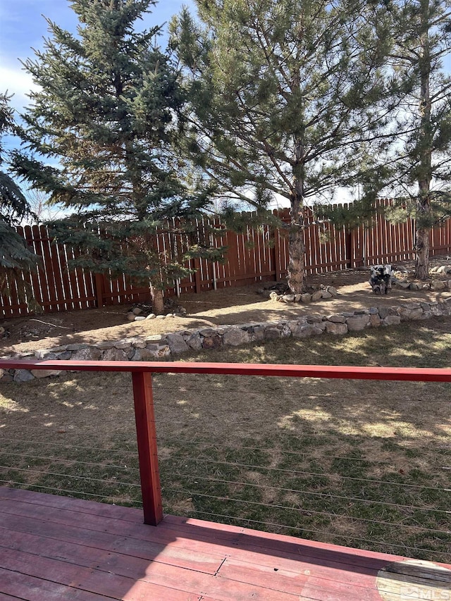 view of yard with a deck and fence