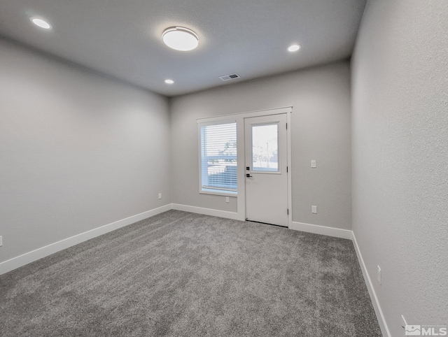 carpeted spare room with visible vents, recessed lighting, and baseboards