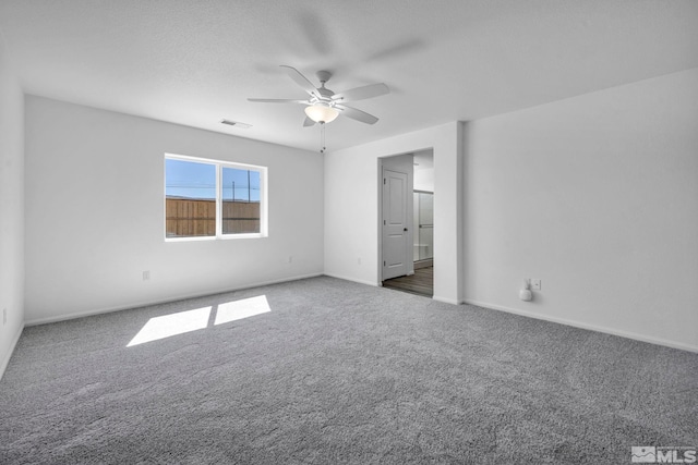 unfurnished bedroom with carpet, baseboards, ceiling fan, and visible vents